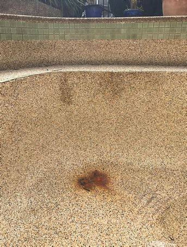 How do you remove rust from a gunite pool
