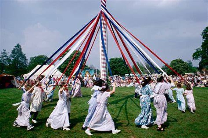 Why do people dance around the Maypole